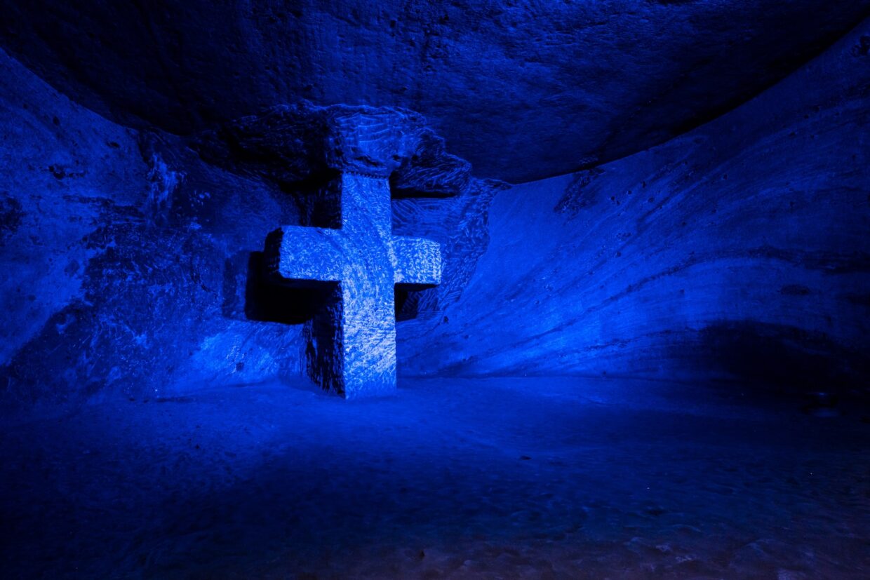 cross in a cave with blue light